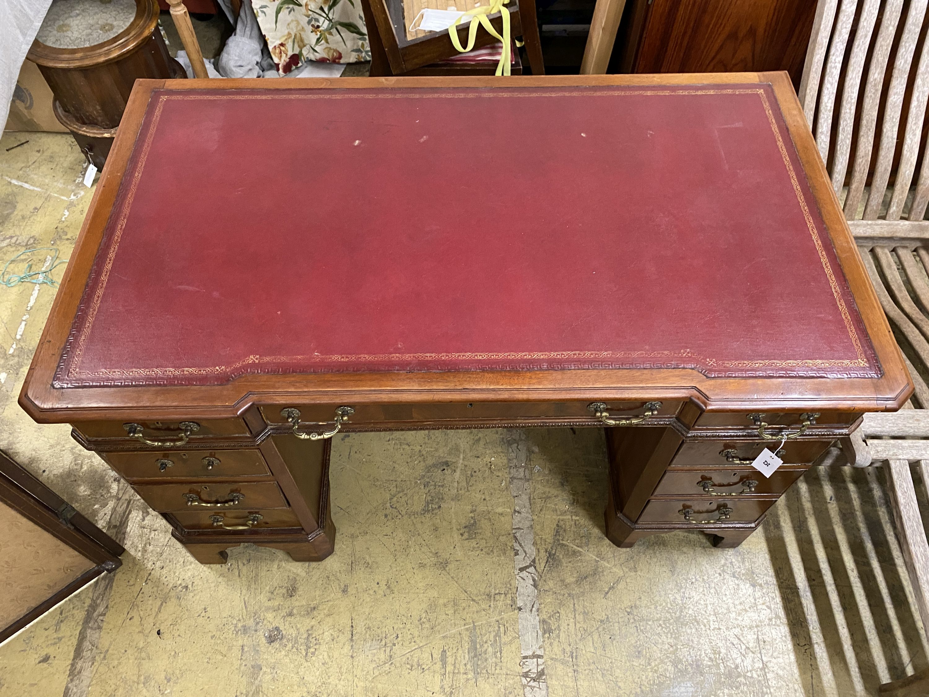 A mahogany breakfront pedestal desk, width 135cm